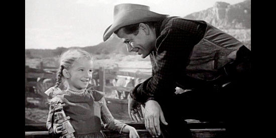 Glenn Ford as Dunn Jeffers, making friends with young Mary Barrett (Janine Perreau) in The Redhead and the Cowboy (1951)