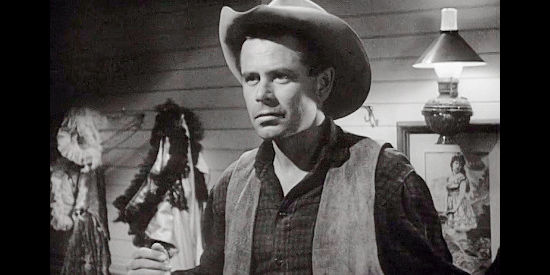 Glenn Ford as Gil Kyle, a cowboy who winds up having to prove himself innocent in a killing in The Redhead and the Cowboy (1951)
