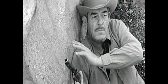 Glenn Strange as the Cedar City sheriff, pinned down in his pursuit of the bandits in The Last Stagecoach West (1957)