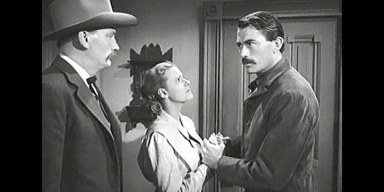 Gregory Peck as Jimmy Ringo (right) insisting to Marshal Strett (Millard Mitchell) and Peggy (Helen Wescott) that he see his son before leaving Cayenne in The Gunfighter (1950)