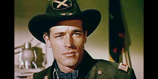 Guy Madison as Maj. Will Denning, facing a surprise reunion with Kathy Summers at Monrovia in Drums in the Deep South (1951)