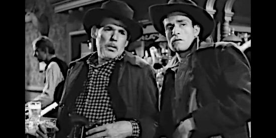 Henry Hull as Hank Younger and Hugh O'Brian as son Lem, eyeing up a stranger who bears an uncanny resemblance to Jesse James in The Return of Jesse James (1950)