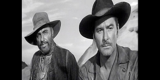 Howard Petrie as Cole Smith and Errol Flynn as Capt. Lafe Barstow, watching Indian trouble approach in Rocky Mountain (1950)