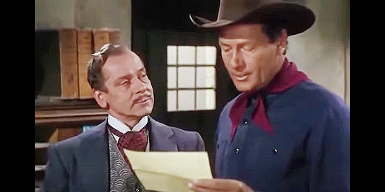 Ivan Triesault as Baron Von Hollden and Joel McCrea as Clete Mattson discussing supplies for the Confederate Army in Border River (1954)