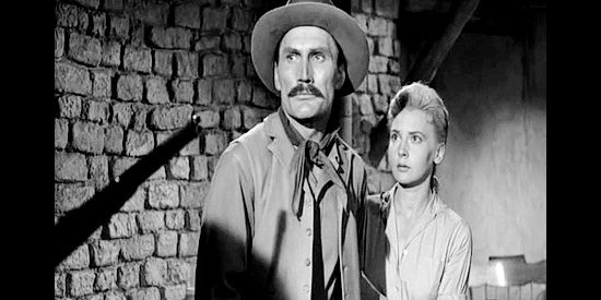 Jack Palance as Jacob Wade and Elaine Aiken as Ada, threatened by one of Jacob's former saddle mates in The Lonely Man (1957)