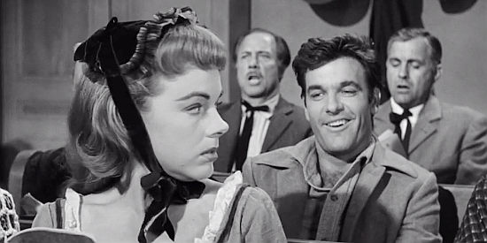 James Best as Sam Mullen, playing footsy with Janet Calvert (Terry Moore) in church in Cast a Long Shadow (1959)