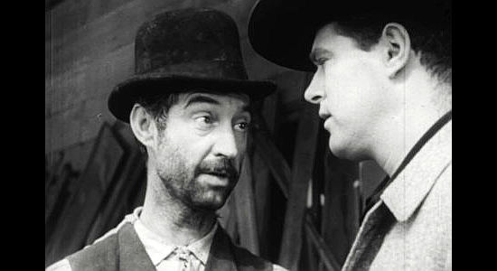 James Griffith as Papa Clellan, filling John Trey (Charles Quinlivan) in on his plans to steal an Army gold shipment in Seven Guns to Mesa (1958)