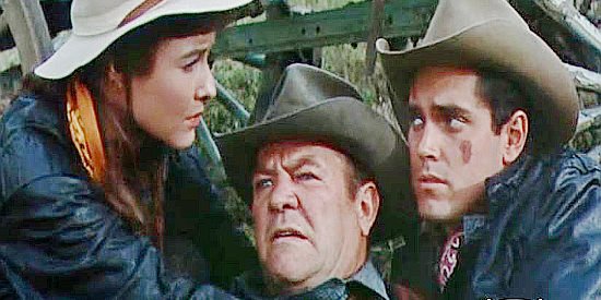 Janice Rule as Aud Niven and Jeffrey Hunter as Bless Keough, helping Aud's dad Andy (Paul Birch) when he breaks his leg in Gun for a Coward (1956)