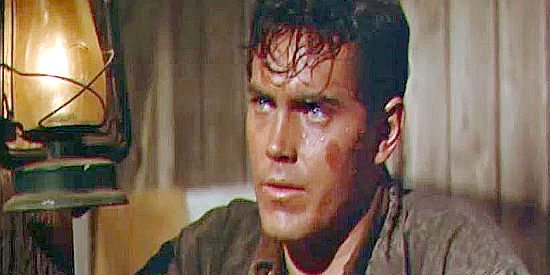 Jeffrey Hunter as Bless Keough, torn between pleasing his mother and staying on the ranch and proving his manhood in Gun for a Coward (1956)