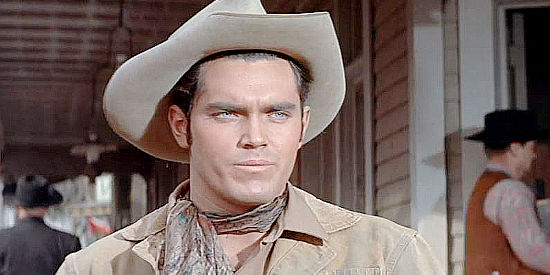 Jeffrey Hunter as Thad Anderson, unsure whether or not he can trust Cass Silver in The Proud Ones (1956)