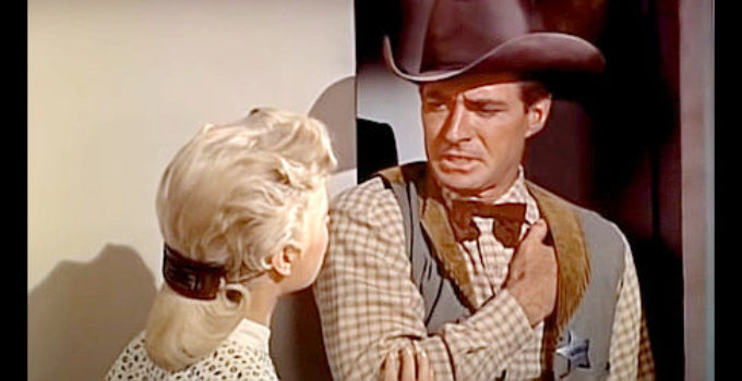Jock Mahoney as Jim Trask, wounded and running into Peggy Bigalow (Martha Hyer) in Showdown at Abilene (1956)
