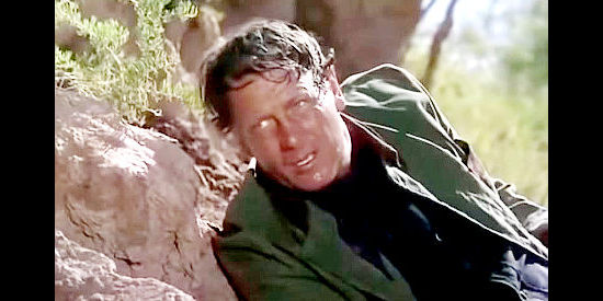 Joel McCrea as Maj. Clete Mattson, nearly drowned but reaching his destination on the Mexico side of the Rio Grande in Border River (1954)