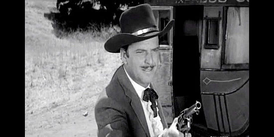 John Carroll as Clint Jones, dealing with men trying a stage holdup in Plunderers of Painted Flats (1959)