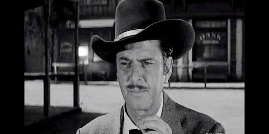 John Carroll as Clint Jones, the hired gunman summoned by Ed Sampson in Plunderers of Painted Flats (1959)