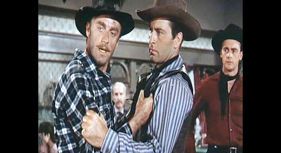 John Dehner as Emil Cabeau in a dispute with Bret Ivers (George Montgomery) as Larry Gallad (Jerome Courtland) looks on in Cripple Creek (1952)