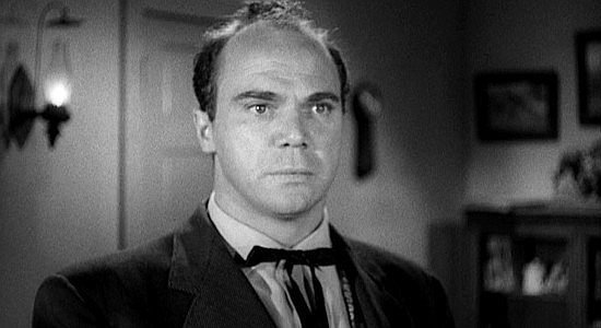 John Doucette, surprised when an old acquaintance shows up in Cold Water, the town where he runs a profitable saloon in The Forty-Niners (1954)