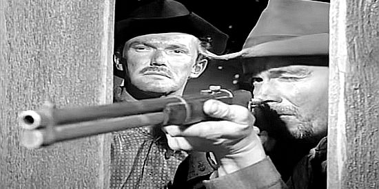 John Kellogg as Slater, watching one of his gang members take aim during a stage holdup in The Silver Whip (1953)