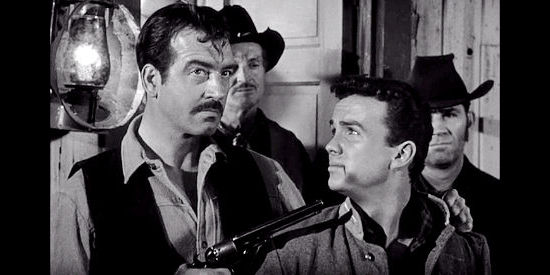John Payne as John Willoughby, with a gun on Gray Mason (Ben Cooper) in Rebel in Town (1956)