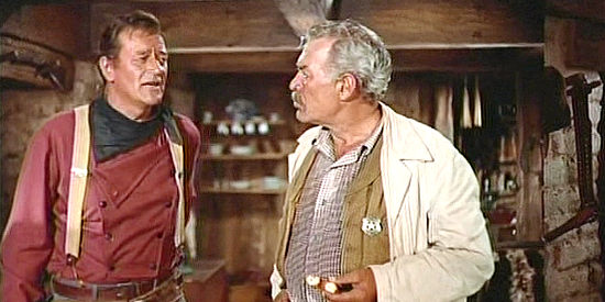 John Wayne as Ethan Edwards with Ward Bond as Texas Ranger Capt. Samuel Clayton in The Searchers (1956)