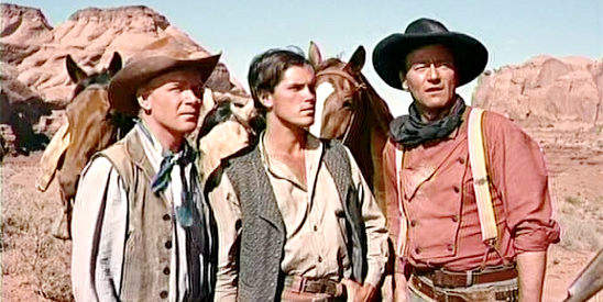 John Wayne (right) as Ethan Edwards with fellow searchers Brad Jorgenson (Harry Carey Jr.) and Martin Pawley (Jeffrey Hunter) in The Searchers (1956)