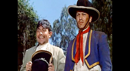 Jose Angel Espinosa Ferrusquilla as Felipe with one of Miguel Delmonte's vaqueros in Sierra Baron (1958)