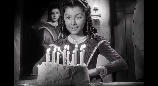 Karen Kester as young Sofia, amazed by her grand birthday cake in The Baron of Arizona (1950)