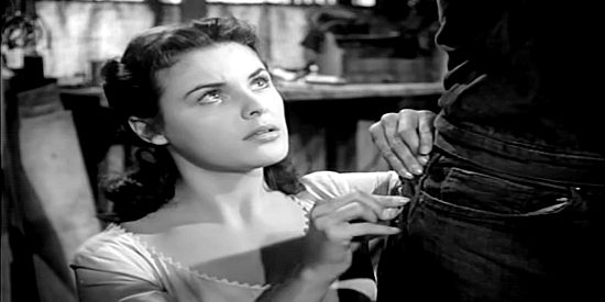 Kathleen Crowley as Kathy Riley, stitching up the pants of boyfriend Jess Harper in The Silver Whip (1953)