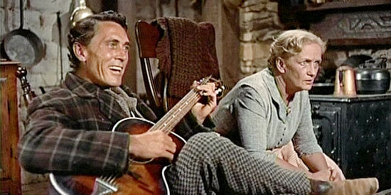 Ken Curtis as Charlie McCoy and Olive Carey as Mrs. Jorgenson, listening to Laurie read a letter from Martin in The Searchers (1956)