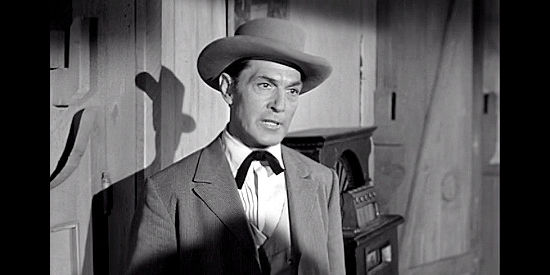 Kent Taylor as Anse Conroy, the gun runner among the those trapped in Ghost Town (1955)