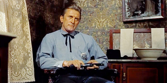 Kirk Douglas as Marshal Matt Morgan, keeping a close eye on his prisoner in Last Train from Gun Hill (1959)