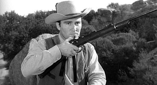 Lane Bradford as Bill Norris, realizing a pretend killer never he fired his gun in The Forty-Niners (1954)