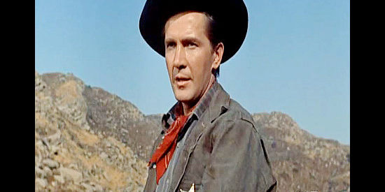 Lin McCarthy as Sheriff Mark Riley, a young lawman endangering his life by tangling with cattle king Reed Williams in Face of a Fugitive (1959)