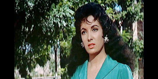 Linda Cristal as Maria O'Reilly, intrigued by the man who caught her bathing and swiped her scarf in The Last of the Fast Guns (1958)