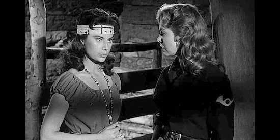 Lisa Montell as Tula, a chief's daughter, trying to find a way to help white friend Elen Carter (Susan Cummings) in Tomahawk Trail (1957)