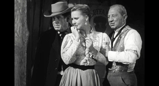 Lola Albright as Julie Weston watching a fistfight while being comforted by Sam Denton (Jack Carr) and Ben Avery (Jay Alder, right) in Seven Guns to Mesa (1958)