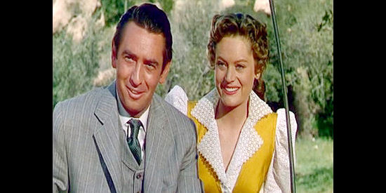 MacDonald Carey as Pete Carver and Alexis Smith as Elizabeth Trent, out for a buggy ride in Cave of Outlaws (1951)