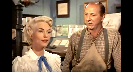 Madalyn Trahey as newspaperwoman Ellie McCloud with her assistant Ben (Joe Sodja) in The Parson and the Outlaw (1957)