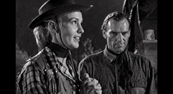 Maria Hart as Queenie Hart, her prayer for rain answered as Bill Foster (Drake Smith) gets wet in Cattle Queen (1951)