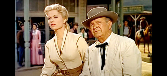 Martha Hyer as Peggy Bigalow with her father Ross (Harry Harvey) watching an altercation play out in Showdown at Abilene (1956)