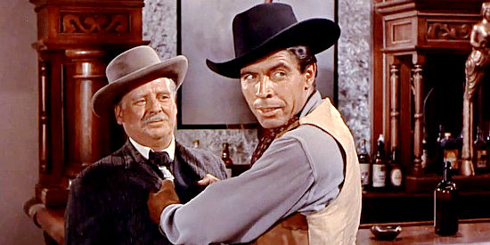 Michael Pate as Harley Baskam, a hired gun harassing Dr. Amos Wynn (Wallace Ford) in A Lawless Street (1955)