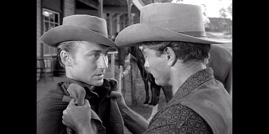 Nick Adams as Tracy Mitchell, being scolded by brother Brock (John Derek) in Fury at Showdown (1957)