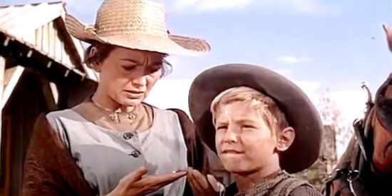 Olivia de Havilland as Linnett Moore, meeting David Chandler (David Ladd) with the help of the message he wears around his neck in The Proud Rebel (1958)