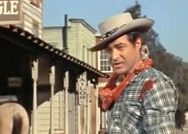 Anthony Dexter as Billy the Kid, wounded but still standing after reluctantly strapping on his six-gun again in The Parson and the Outlaw (1957)