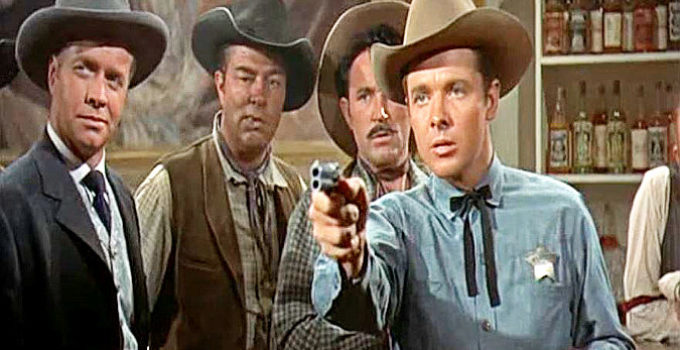 Audie Murphy as Tom Destry, showing he's quite adept at using a gun while Decker (Lyle Bettger) looks on in Destry (1954)