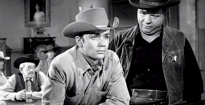 Ben Cooper as Jeff Blaine, ignoring the advice of Marshal Blessingham (Charles Watts) in The Outlaw's Son (1957)