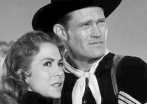 Chuck Connors as Sgt. Wade McCoy tries to comfort Ellen Carter as she frets about an Indian attack in Tomahawk Trail (1957)