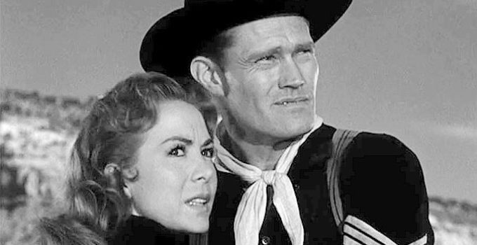 Chuck Connors as Sgt. Wade McCoy tries to comfort Ellen Carter as she frets about an Indian attack in Tomahawk Trail (1957)