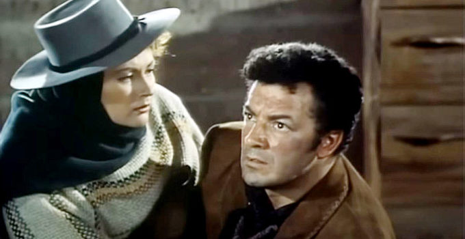 Cornel Wilde as Juan Obregon, getting a bit of welcome news from Tona (Yvonne De Carlo) in Passion (1954)