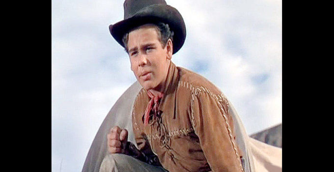 Dean Stockwell as Chester Graham Jr., cheering on new friend Dan Mathews during a horse race in Cattle Drive (1951)