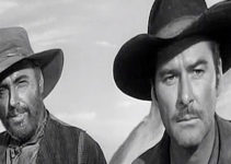 Howard Petrie as Cole Smith and Errol Flynn as Capt. Lafe Barstow, watching Indian trouble approach in Rocky Mountain (1950)